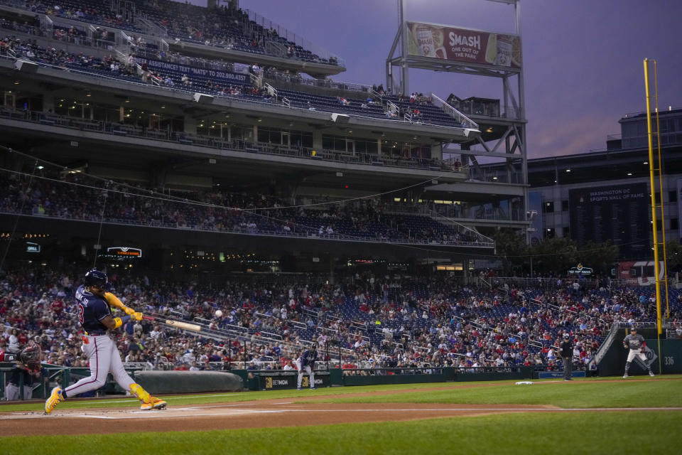 Atlanta Braves' Ronald Acuna Jr. hits a solo home run during the first inning of a baseball game against the Washington Nationals at Nationals Park, Friday, Sept. 22, 2023, in Washington. With the hit, Acuna became the fifth player in MLB history with 40 home runs and 40 stolen bases in a season. (AP Photo/Andrew Harnik)