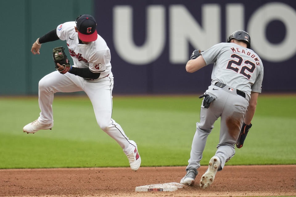 Cleveland Guardians second baseman Andrés Giménez, left, jumps out of the way after forcing out Detroit Tigers' Parker Meadows (22) at second in the second inning of a baseball game Monday, May 6, 2024, in Cleveland. (AP Photo/Sue Ogrocki)