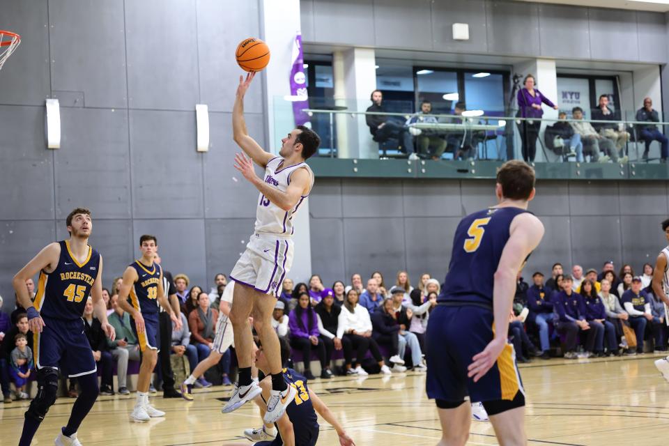 Hayden Peek, playing for the NYU men's basketball team, gets off a floater in the lane during a Jan. 22 game against Rochester.