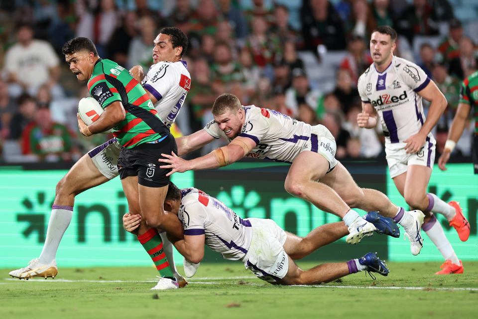 Seen here, Rabbitohs star Latrell Mitchell being tackled against the Melbourne Storm in round five of the NRL. 