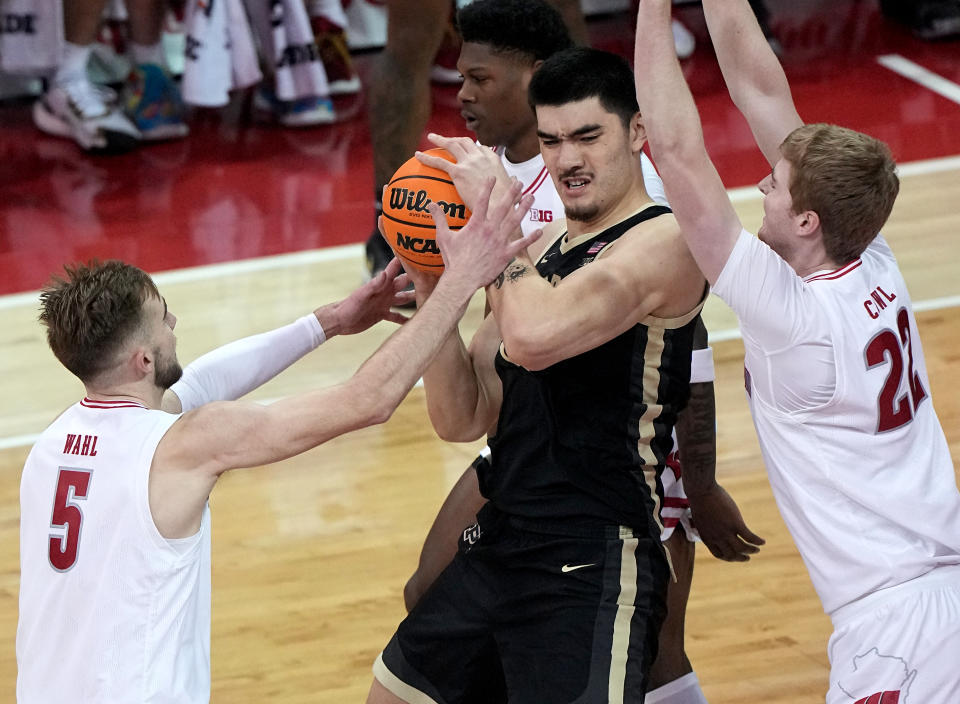 Feb 4, 2024; Madison, Wisconsin, USA; Purdue’s Zach Edey (15) is swamped by Wisconsin forward Tyler Wahl (5) and forward Steven Crowl (22) during the first half at Kohl Center. Mandatory Credit: Kayla Wolf-USA TODAY Sports