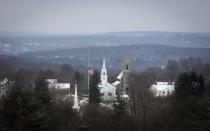 The town flag flies at half staff in Newtown, Connecticut December 14, 2013. Today marks the one year anniversary of the shooting rampage at Sandy Hook Elementary School, where 20 children and six adults were killed by gunman Adam Lanza. (REUTERS/Carlo Allegri)