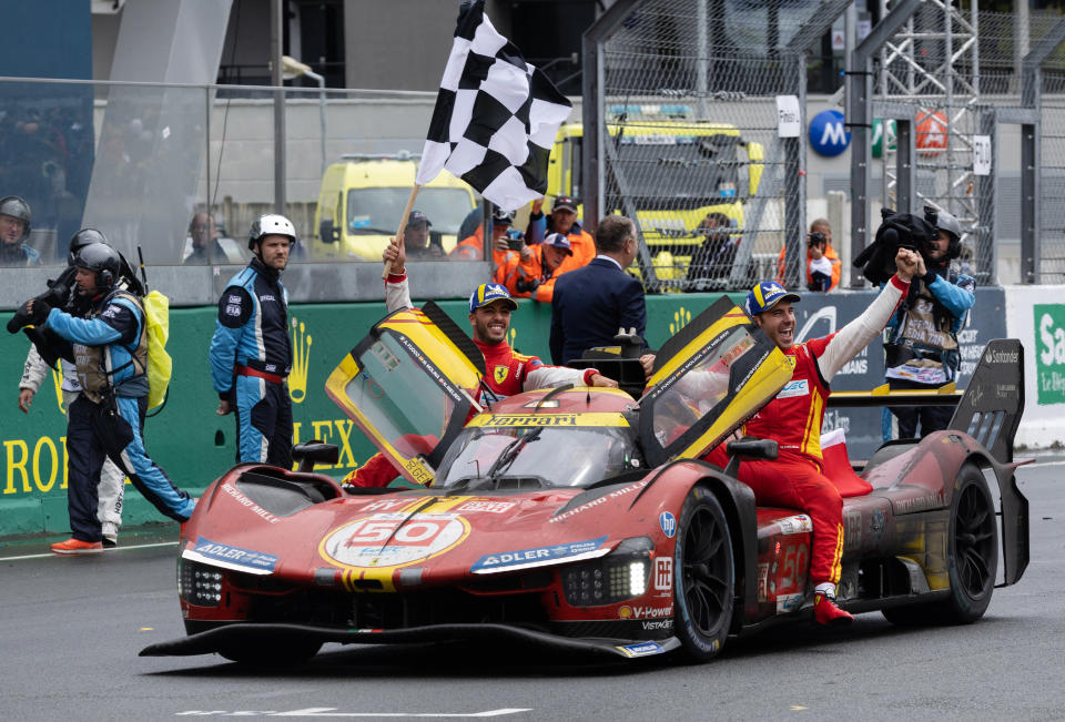 Ferrari drivers Antonio Fuoco (L), Miguel Molina (R) and Nicklas Nielsen (in the car) celebrate their victory. (Fred Tanneau/AFP via Getty Images)