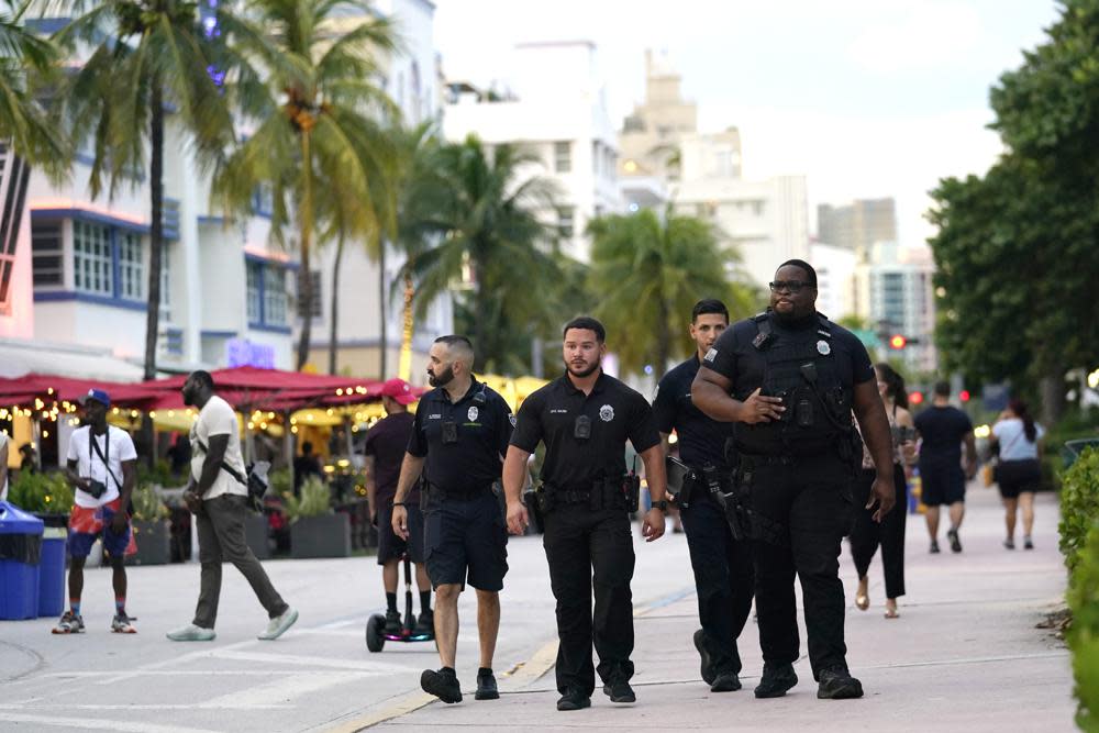 City of Miami Beach code enforcement and police officers patrol along Ocean Drive, Friday, Sept. 24, 2021, in Miami Beach, Fla. (AP Photo/Lynne Sladky)