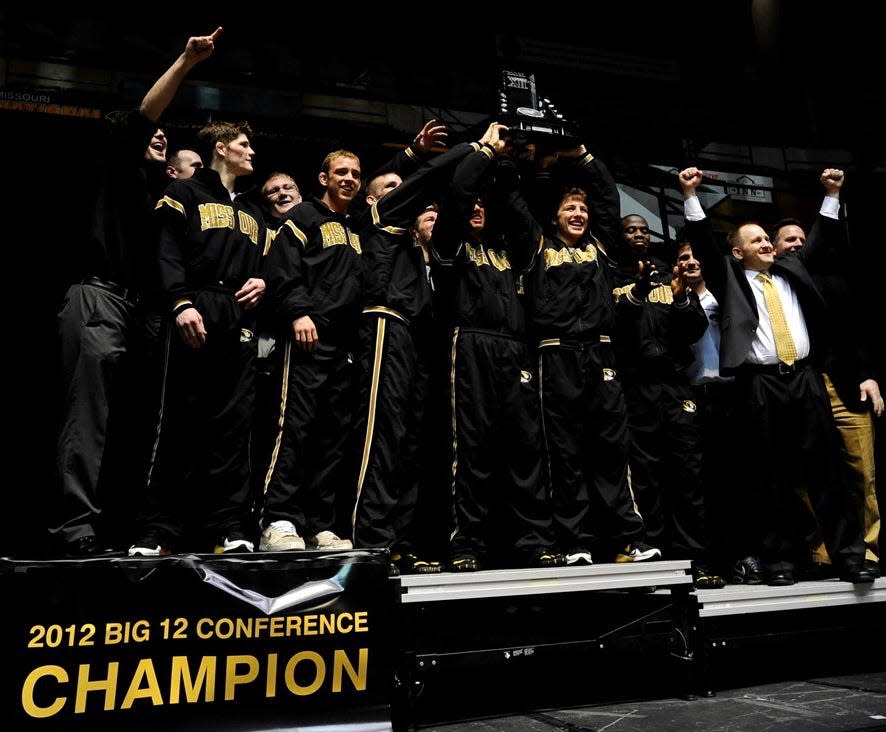 Members of the Missouri wrestling program celebrate their 2012 Big 12 Conference championship at the Hearnes Center.