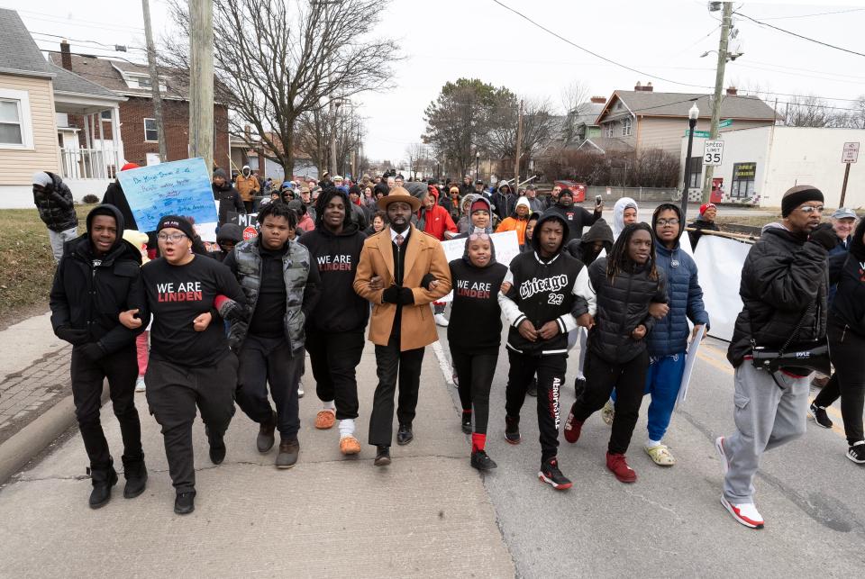 Jan 16, 2023; Columbus, Ohio, USA;  March co-organizer Londale Towns links arms with other participants at the end of the We Are Linden Annual MLK March. Mandatory Credit: Brooke LaValley/Columbus Dispatch