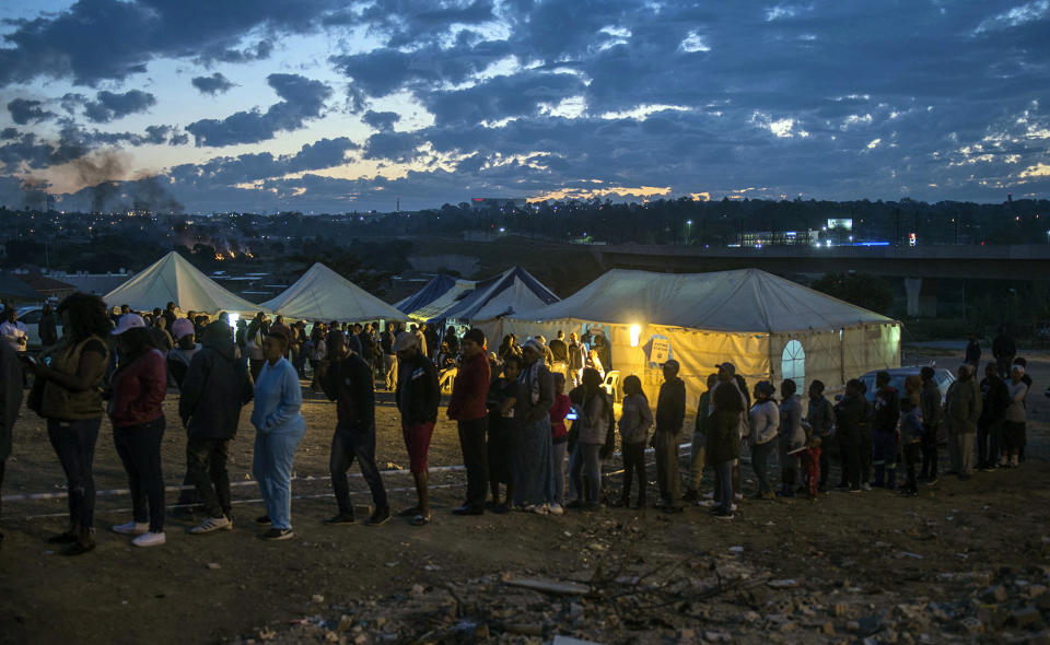 Residents of Alexandra Township queue to cast their votes in Johannesburg, Wednesday, May 8, 2019. South Africans are voting Wednesday in a national election that pits President Cyril Ramaphosa's ruling African National Congress against top opposition parties Democratic Alliance and Economic Freedom Fighters, 25 years after the end of apartheid. (AP Photo/Mujahid Safodien)