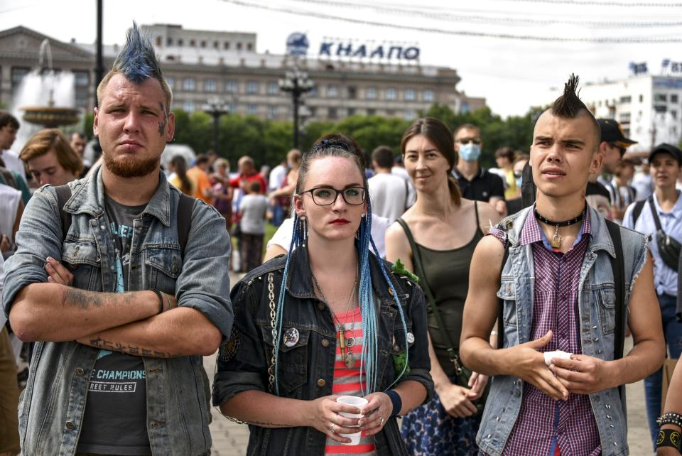 People attend a rally supporting Khabarovsk region's governor Sergei Furgal, during an unsanctioned protest in support of Sergei Furgal, who was interrogated and ordered to be held in jail for two months, in Khabarovsk, 6,100 kilometers (3,800 miles) east of Moscow, Russia, Saturday July 25, 2020. Many thousands of people have marched across the far eastern Russian city of Khabarovsk to protest the arrest of the regional governor on murder charges, continuing a wave of protests that has lasted for two weeks in a challenge to the Kremlin. (AP Photo/Igor Volkov)