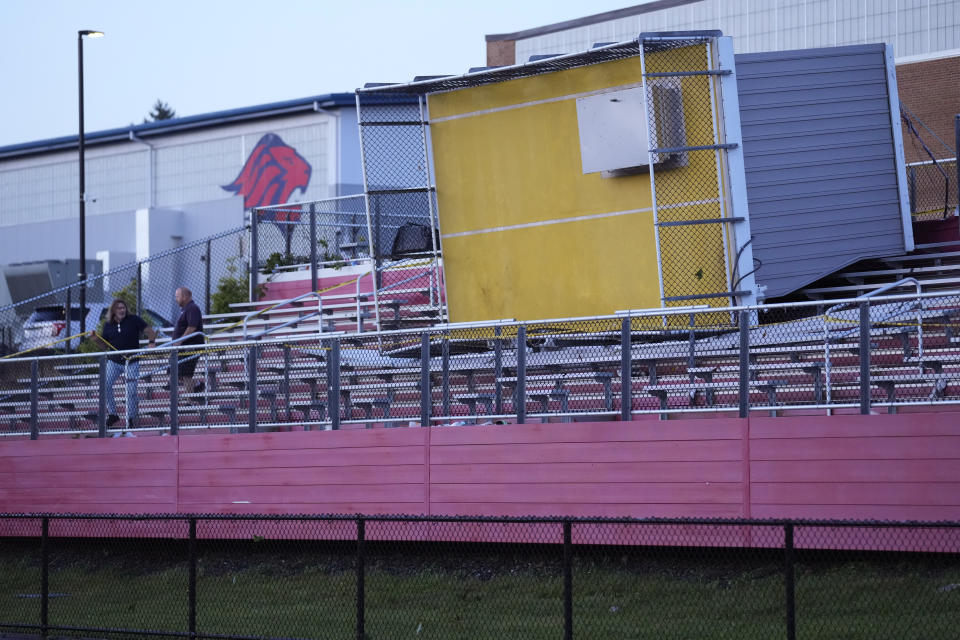 School employees John Houle, left, and Chris Herman examine damage from a severe storm that toppled a press box at Ferguson Field at Lincoln High School in Lincoln, R.I., Thursday, Sept. 14, 2023, in Leominster, Mass.(AP Photo/Robert F. Bukaty)