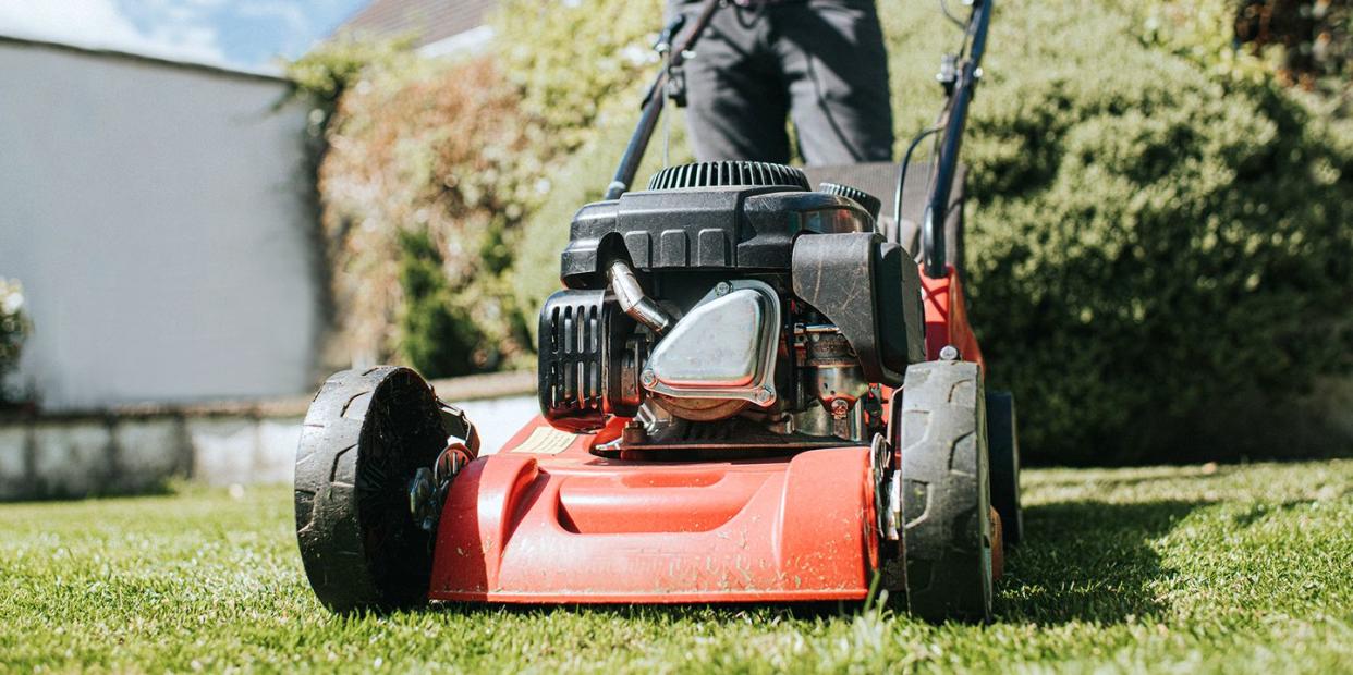 man pushing lawn mower