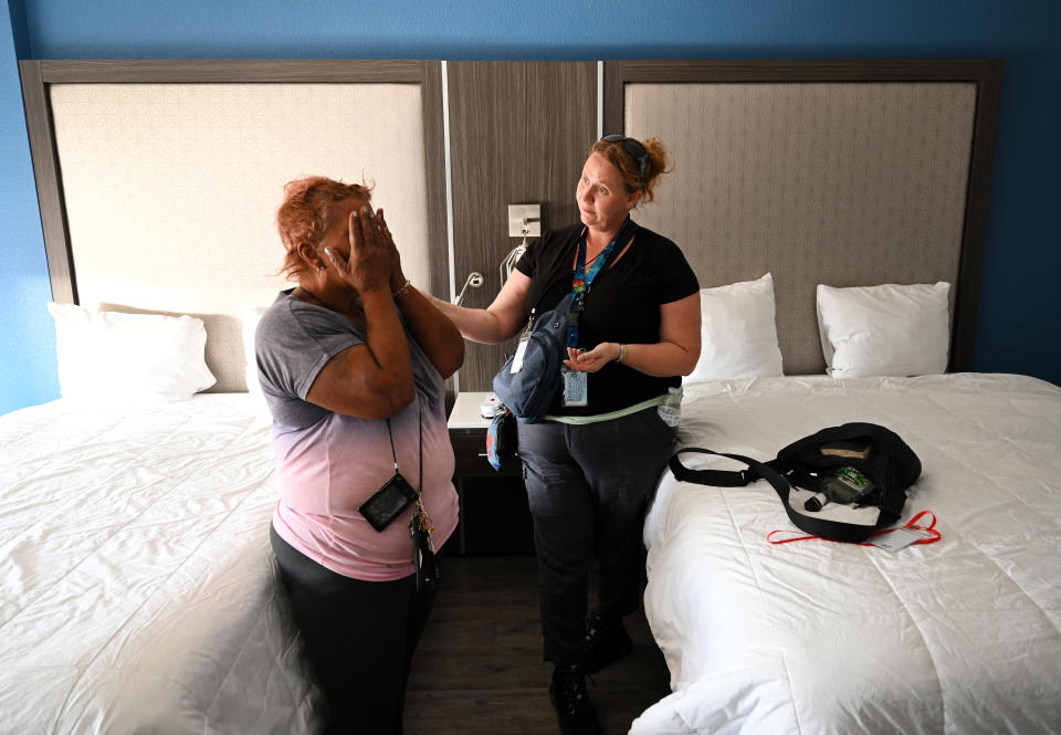 DENVER, CO - SEPTEMBER 25: Cecilia Montielh is comforted by facilities manager Tasha Fordyce, right, as she gets emotional after walking into her own hotel room where she will be able to stay for 90 days on September 25, 2023 in Denver,  Colorado. Montielh was living at an encampment along North Logan street and E. Eighth ave. DUnder the guidance of newly elected Mayor Michael Johnston, the city of Denver is doing sweeps of  homeless encampments in Denver but instead of forcing the unhoused to move they are offering the residents in the encampments someplace else to go. In this case a hotel. Denver city crews and outreach workers helped those living in the large encampment at East Eighth Ave and Logan streets to pack up their belongings. Crews gave large bags to people who were able to pack their personal items onto trucks that then delivered them to the hotel. 72 people were given rooms in newly bought hotels that have been converted into a non-congregate homeless shelters. Buses transported the people transitioning from the camp to the hotel shelter. People were able to take all of their belongings and their pets. Officials with the city say that these hotels and micro-communities aim to provide support and help people transition to permanent housing in a 6-12 month timeframe.  (Photo by Helen H. Richardson/MediaNews Group/The Denver Post via Getty Images)