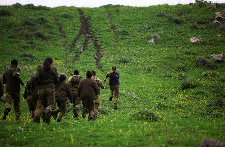 Female Israeli soldier, Lotem Stapleton (R), a physical education officer, runs during a training session in Krav Maga, an Israeli self-defence technique, at a military base in the Israeli-occupied Golan Heights March 1, 2017. REUTERS/Nir Elias