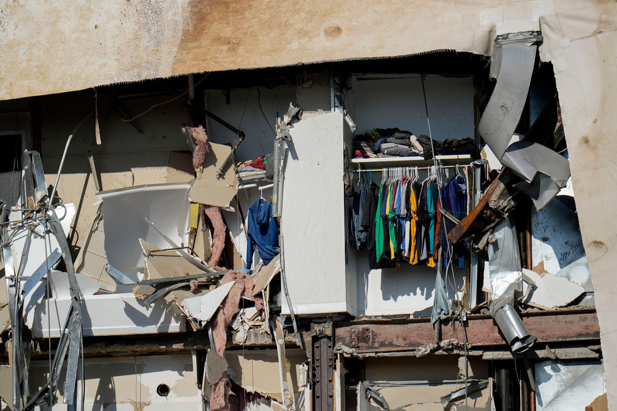 Clothing hanging in an apartment of the building that partially collapsed. (Erin Hooley / AP)