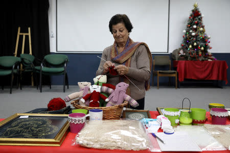 Efaf Srouji knits during a Christmas workshop to teach embroidery in the northern Israeli city of Nazareth, December 6, 2018. Picture taken December 6, 2018. REUTERS/Ammar Awad