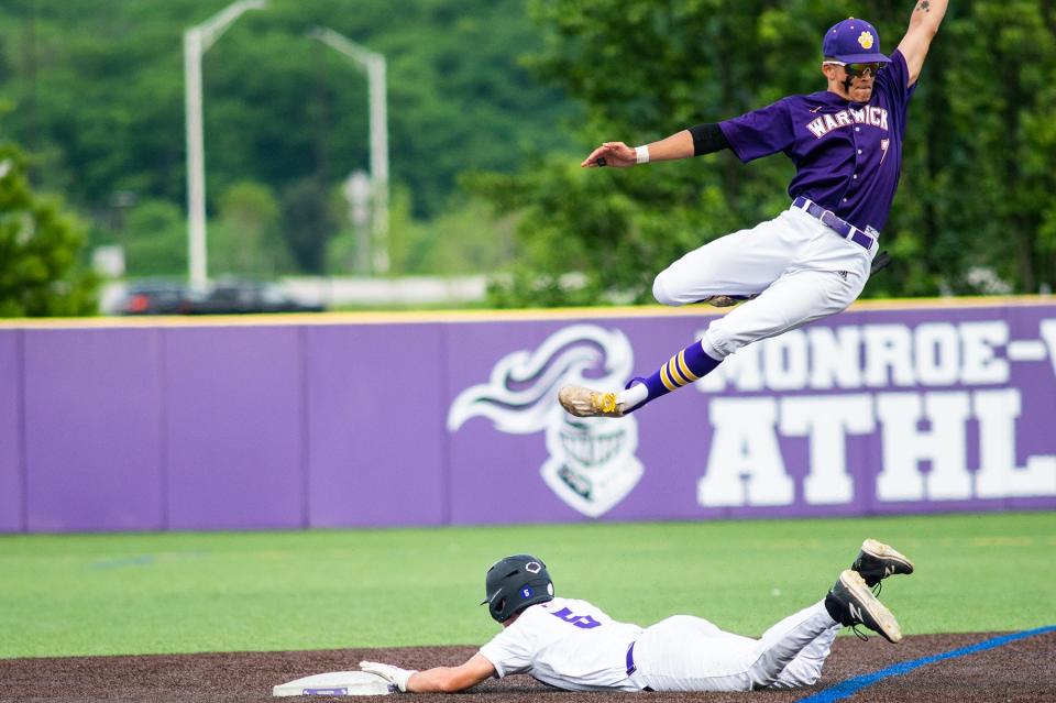 Monroe-Woodbury's James Mastropolo slides to second base as Warwick's Chase Fogg's leaps up to get the ball during the section 9 Class AA quarterfinal baseball game at Monroe-Woodbury High School in Central Valley, NY on Monday, May 23, 2022. Warwick defeated Monroe-Woodbury 3-1. KELLY MARSH/FOR THE TIMES HERALD-RECORD