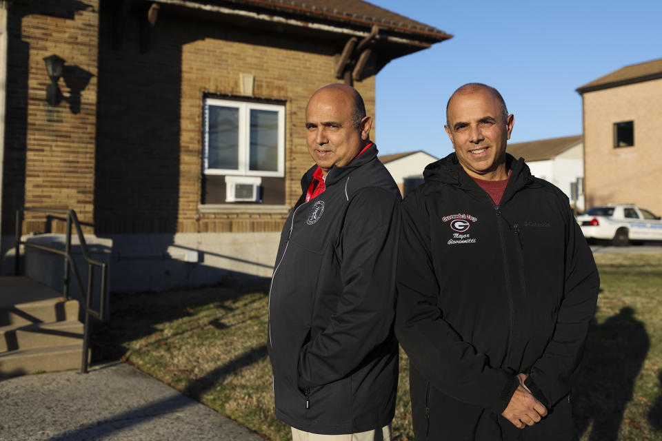 John Giovannitti, left, mayor-elect of Paulsboro, and brother Vince Giovannitti, mayor of Greenwich Township, stand together for a portrait outside of the Greenwich Township Municipal Building in Gibbstown, N.J., on Tuesday, Dec. 12, 2023. (Heather Khalifa/The Philadelphia Inquirer via AP)