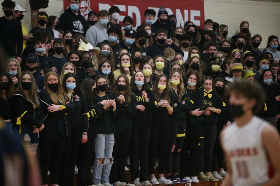 Spectators wear yellow ribbons for Zach Osterhoudt as they watch Friday's boys basketball game between Highland and Red Hook. Osterhoudt was diagnosed with a rare form of cancer and this game had a fundraiser for him and his family.