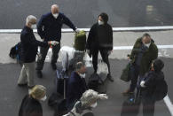 Members of a WHO team arrives in Wuhan in central China's Hubei province on Thursday, Jan. 14, 2021. The global team of researchers arrived Thursday in the Chinese city where the coronavirus pandemic was first detected to conduct a politically sensitive investigation into its origins amid uncertainty about whether Beijing might try to prevent embarrassing discoveries. (AP Photo/Ng Han Guan)