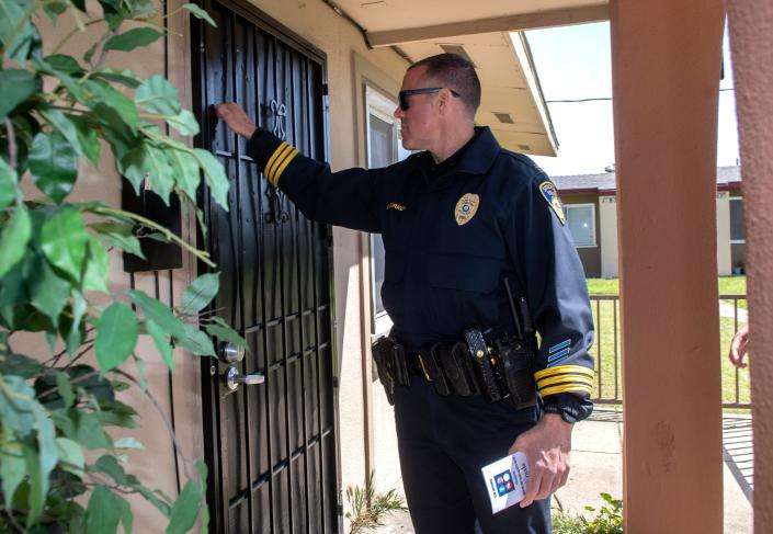 Stockton Police captain Brad Burrell knocks on a door during a Police Chief's neighborhood walk through the Sierra Vista area of south Stockton. In March, the area experiences 2 double murders.