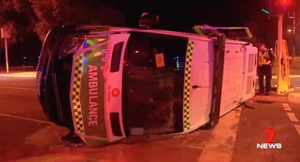 A Perth driver who police say was on the wrong side of the road after running a red light has ploughed into an ambulance. Source: 7 News