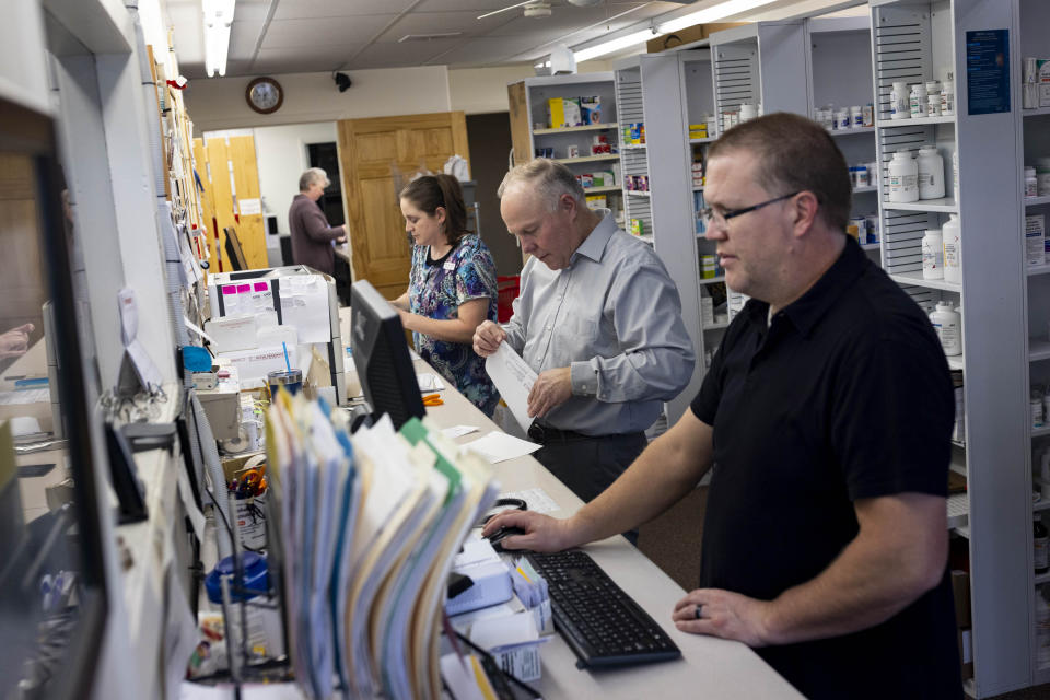 Craig Jones, center, works with the other pharmacists and pharmacy technicians to fill prescriptions at Basin Pharmacy in Basin, Wyo., on Wednesday, Feb. 21, 2024. (AP Photo/Mike Clark)