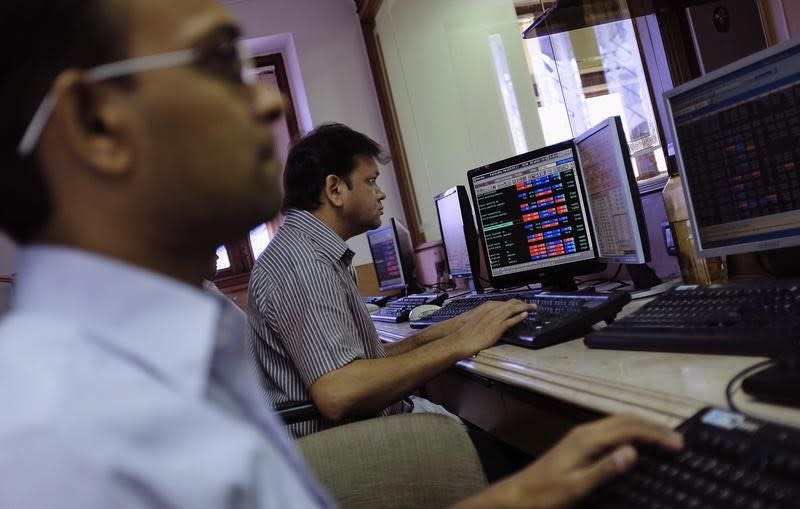 Brokers trade on their computer terminals at a stock brokerage firm in Mumbai May 13, 2014. REUTERS/Danish Siddiqui/Files