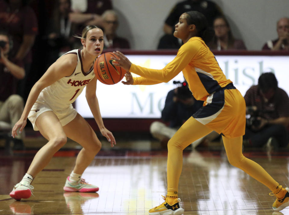 Virginia Tech's Carleigh Wenzel, left, defends against UNC-Greensboro's Jayde Gamble, right, in the first half of an NCAA college basketball game in Blacksburg, Va., Monday, Nov. 20 2023. (Matt Gentry/The Roanoke Times via AP)