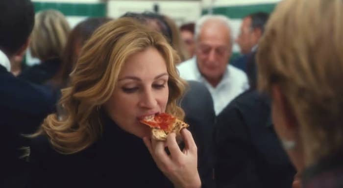 a scene from eat, pray, love of julia roberts eating pizza