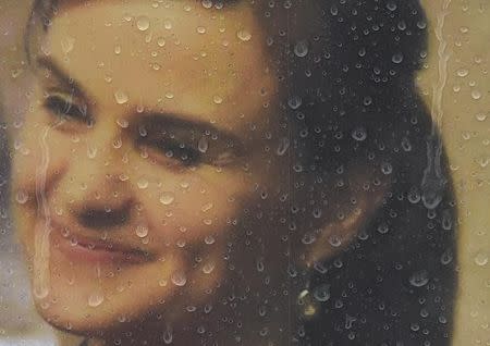 Rain drops land on a framed photograph of murdered Labour Party MP Jo Cox, who was shot dead in Birstall, at Parliament Square in London, Britain June 20, 2016. REUTERS/Toby Melville/Files