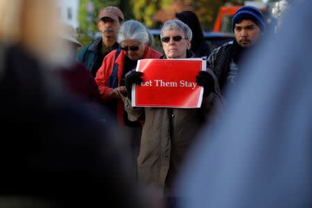 FILE PHOTO: Demonstrators hold an "Interfaith Prayer Vigil for Immigrant Justice" outside the federal building, where ethnic Chinese Christians who fled Indonesia after wide scale rioting decades ago and overstayed their visas in the U.S. must check-in with ICE, in Manchester, New Hampshire, U.S. on October 13, 2017. REUTERS/Brian Snyder/File Photo