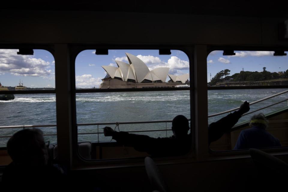 A boat passes the Sydney Opera House.