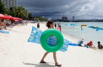 <p>Tourists frolic along the Tumon beach on the island of Guam, a U.S. Pacific Territory, August 10, 2017. (Erik De Castro/Reuters) </p>