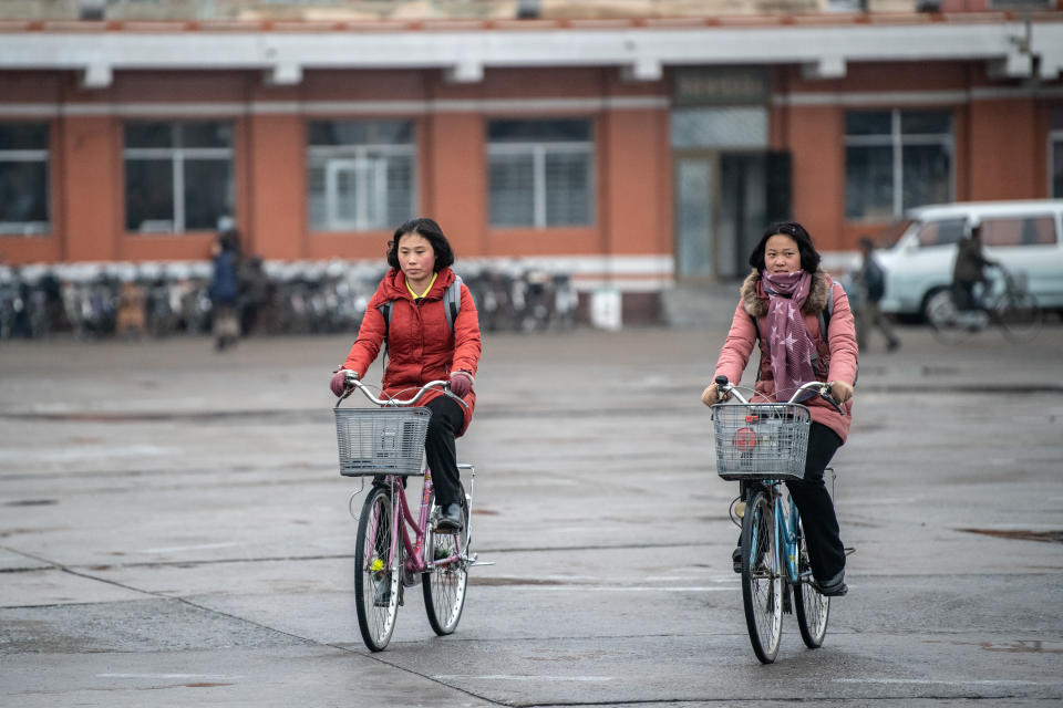 North Korean women cycle across Hamhung Square on Feb. 3, in Hamhung, North Korea.