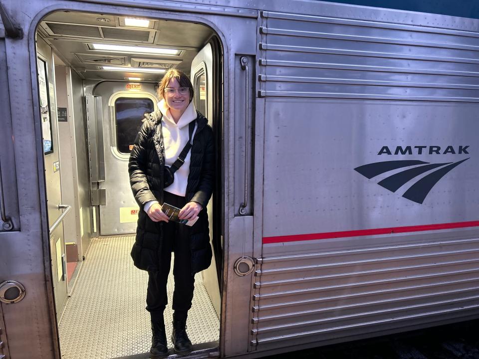 The author stands in the doorway of an Amtrak train.