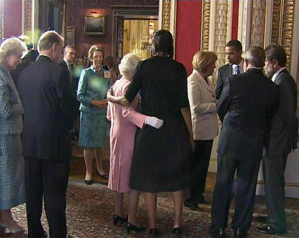A video grab from television footage shows U.S. first lady Michelle Obama (C) standing with Britain's Queen Elizabeth during a reception for G20 leaders at Buckingham Palace in London April 1, 2009. World leaders arrived in London on Wednesday ahead of a G20 summit meeting under intense pressure to produce a morale-boosting response to the worst economic downturn since the 1930s.  REUTERS/POOL via Reuters Tv   (BRITAIN BUSINESS POLITICS ROYALS) FOR EDITORIAL USE ONLY. NOT FOR SALE FOR MARKETING OR ADVERTISING CAMPAIGNS