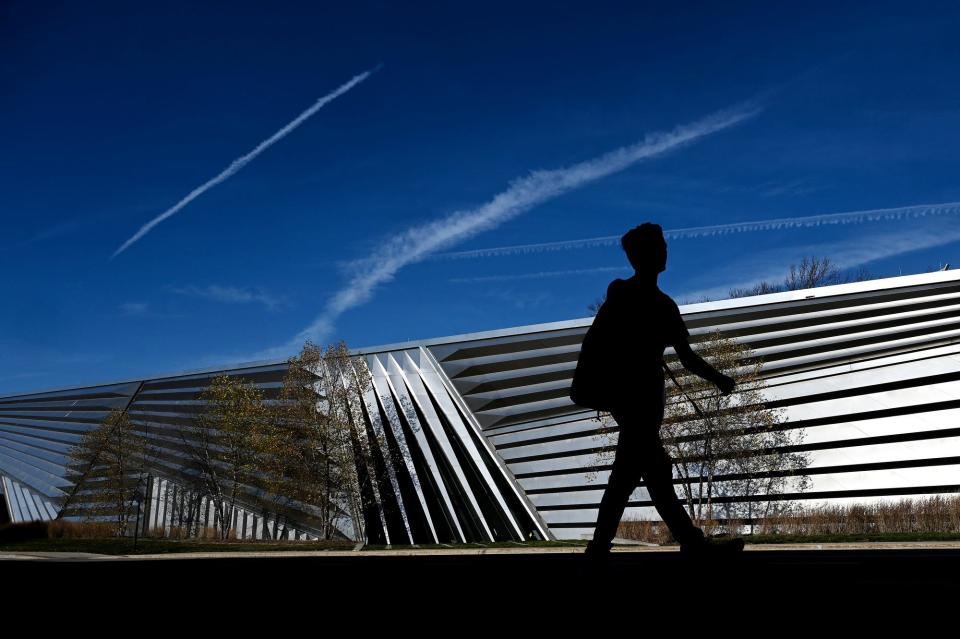A student walks past the Eli and Edythe Broad Art Museum on Thursday, Nov. 10, 2022, on the Michigan State University campus in East Lansing.