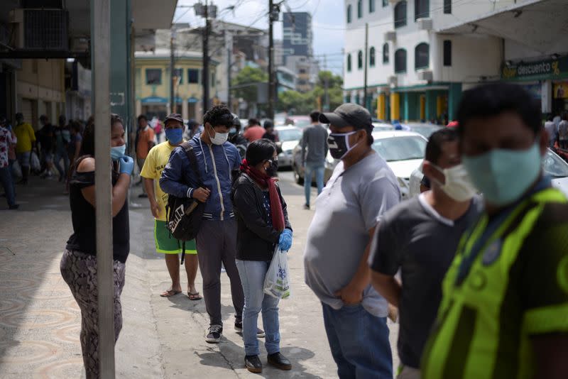 People wait in line to buy supplies amid the spread of the coronavirus disease (COVID-19), in Guayaquil