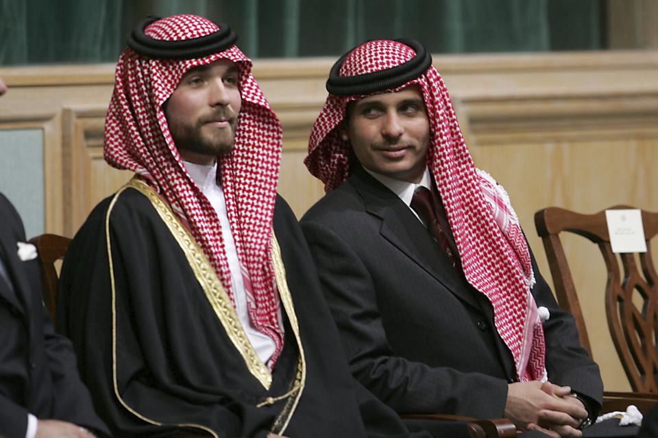 FILE - In this Nov. 28, 2006, file photo, Prince Hamzah Bin Al-Hussein, right, and Prince Hashem Bin Al-Hussein, left, half brothers of King Abdullah II of Jordan, attend the opening of the parliament in Amman, Jordan. Prince Hamzah said in a recording released Monday, April 5, 2021, that he will defy government threats ordering him to stay at home and refrain from public statements following accusations he was behind a plot to destabilize the kingdom. (AP Photo/Mohammad abu Ghosh, File)