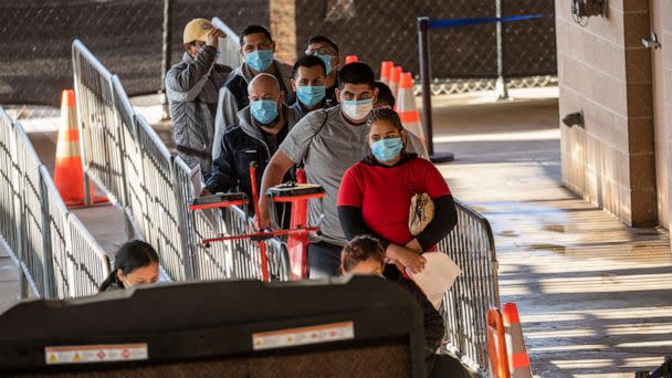 PHOTO: In this Dec. 2, 2022, file photo, immigrants register with authorities after being permitted to seek political asylum in Brownsville, Texas. (John Moore/Getty Images, FILE)