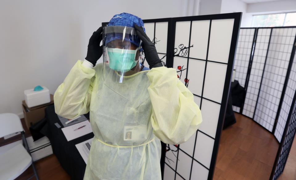 A nurse dons a face shield at a COVID-19 testing facility at the Town of Ramapo Senior Citizen Community Center in Suffern, N.Y., on July 22.