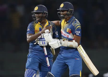 Sri Lanka's Ajantha Mendis (L) and Sachithra Senanayake celebrate after winning their One Day International cricket match against West Indies in Colombo November 1, 2015. REUTERS/Dinuka Liyanawatte