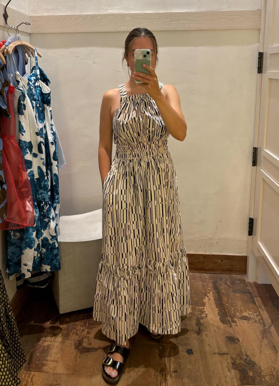 woman wearing white and black halter neck maxi dress, I tried on The Somerset Maxi Dress Poplin Halter Edition — would I buy it? (Photo via Kayla Kuefler).