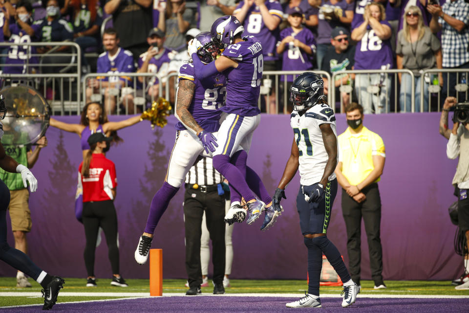 Minnesota Vikings tight end Tyler Conklin (83) celebrates with wide receiver Adam Thielen (19) after scoring a touchdown against the Seattle Seahawks in the first half of an NFL football game in Minneapolis, Sunday, Sept. 26, 2021. (AP Photo/Bruce Kluckhohn)