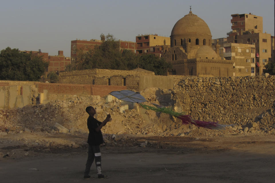 A man flies his kite in front of a domed mausoleum in Cairo's historic City of the Dead, Egypt, Sept. 1, 2023. Authorities have already razed hundreds of tombs and mausoleums as they carry out plans to build a network of multilane highways through the City of the Dead, a vast cemetery in the Egyptian capital that has been in use for more than a millennium. (AP Photo/Amr Nabil)