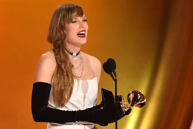 <p>VALERIE MACON/AFP via Getty Images</p> Taylor Swift winning best pop vocal album at the 2024 Grammys in Los Angeles on Feb. 4, 2024