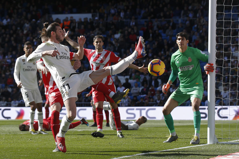 Real Madrid's Gareth Bale, left, tries to control the ball past Girona's goalkeeper Yassine Bounou "Bono" during a La Liga soccer match between Real Madrid and Girona at the Bernabeu stadium in Madrid, Spain, Sunday, Feb. 17, 2019. (AP Photo/Andrea Comas)