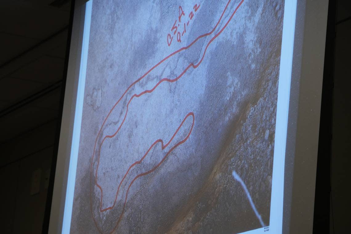 A photo of the stain found underneath Ruben Flores’ house outlined by archaeologist Christine Arrington, who specializes in human remains, is shown to jurors overseeing the Kristin Smart murder trial at Monterey County Superior Court on Sept. 1, 2022.