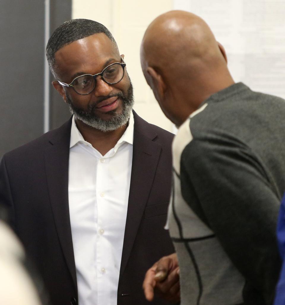 Henry Davis Jr., candidate for the Democratic nomination for South Bend mayor, speaks with poll inspector Ronnie Coleman as he arrives to vote at the voting center at the Charles Black Center Tuesday, May 2, 2023, in South Bend for the 2023 primary election.