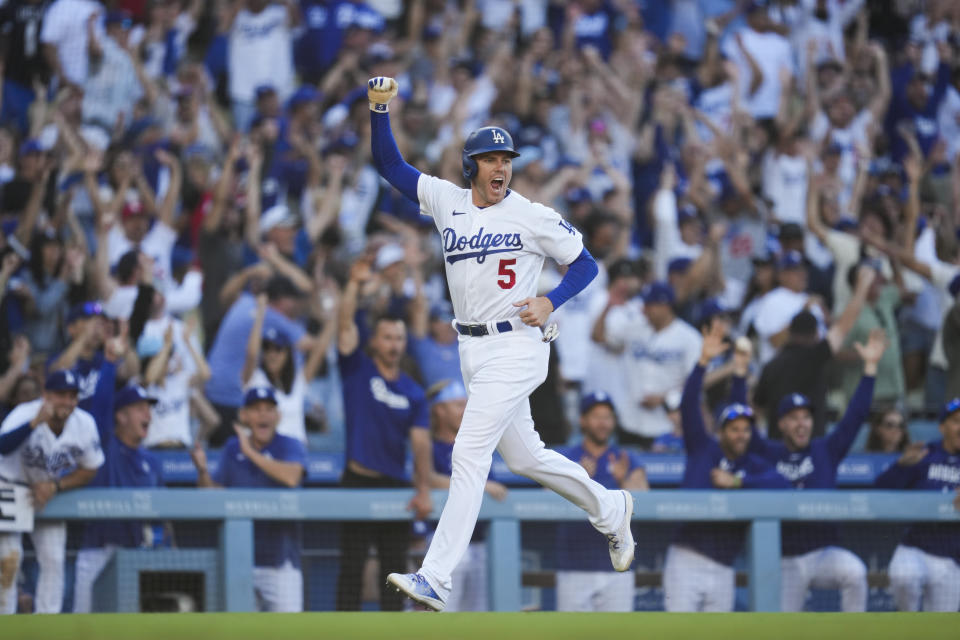 Los Angeles Dodgers' Freddie Freeman (5) celebrates after Will Smith (16) hit a home run during the eighth inning of a baseball game against the Houston Astros in Los Angeles, Sunday, June 25, 2023. They both scored. (AP Photo/Ashley Landis)