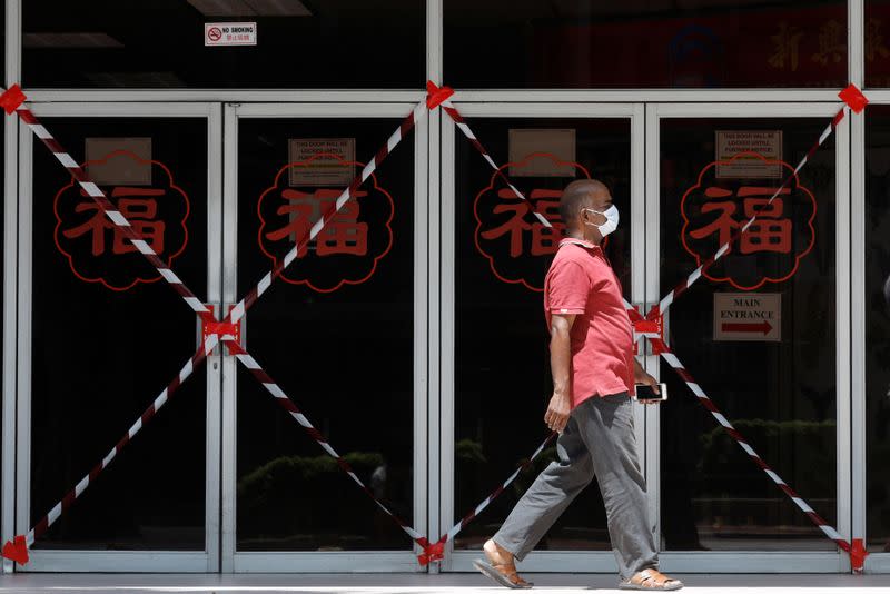 A man passes a closed off mall amid the coronavirus disease (COVID-19) outbreak in Singapore